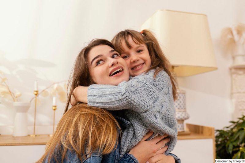 mãe e filha abraçadas, sorrindo, simbolizando que não se deve criar rótulos para as crianças.